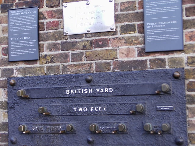 Standard lengths on the wall of the Royal Observatory, Greenwich, London – 1 yard (3 feet), 2 feet, 1 foot, 6 inches (1/2-foot), and 3 inches. The separation of the inside faces of the marks is exact at an ambient temperature of 60 °F (16 °C) and a rod of the correct measure, resting on the pins, will fit snugly between them.