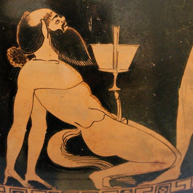 A bald, bearded, horse-tailed satyr balances a winecup on his penis, on an Attic red-figure psykter