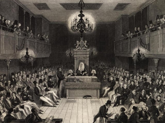 The Speaker presides over debates in the House of Commons, as depicted in the above print commemorating the destruction of the Commons Chamber by fire in 1834.