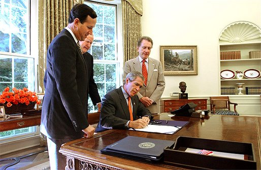 Santorum, Sen. Arlen Specter, and Rep. John Murtha watch President George W. Bush sign the Flight 93 National Memorial Act.
