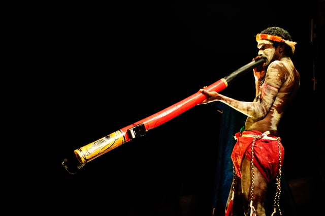 An Indigenous Australian playing the  didgeridoo