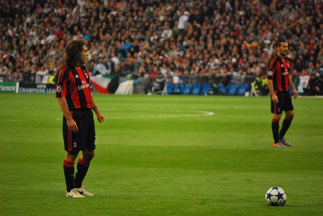Pirlo (left), with Milan, preparing to take a free kick against Real Madrid in the 2010–11 UEFA Champions League.