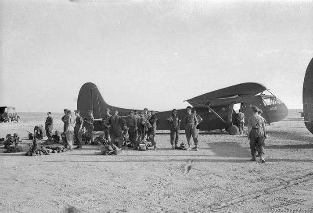 British airborne troops wait to board an American WACO CG4A glider.
