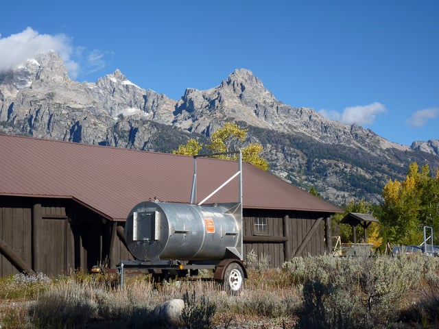 Drum or barrel trap used to safely relocate bears; currently parked adjacent to a building in Grand Teton National Park in Wyoming, United States