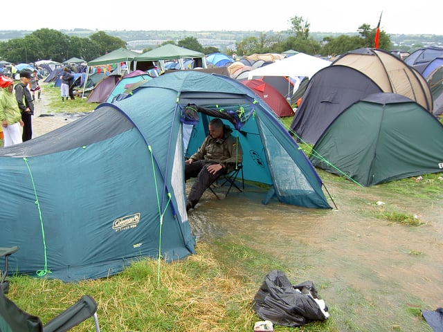 A stream runs through a tent after two inches of rain fell in an hour on Friday morning of the 2005 festival