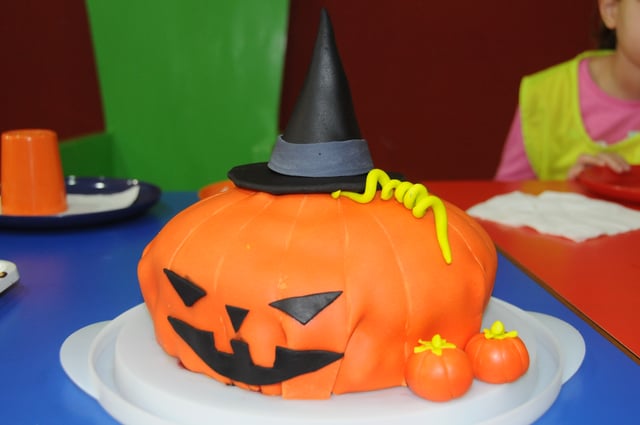 A jack-o'-lantern Halloween cake with a witches hat