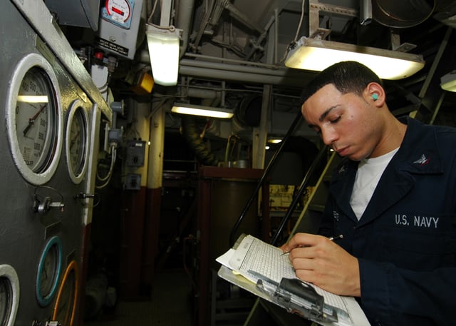 A Machinist's Mate takes readings in the engine room of the multi-purpose amphibious assault ship USS Iwo Jima.