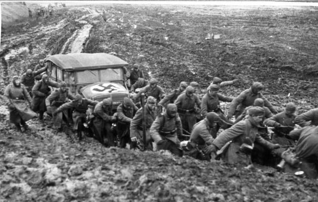 Wehrmacht soldiers pulling a car from the mud during the rasputitsa period, November 1941