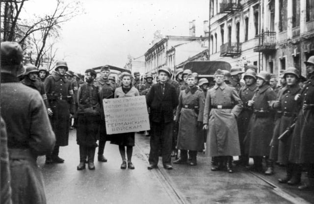 Masha Bruskina  who was a nurse with fellow resistance members before hanging. The placard reads "We are the partisans who shot German troops", Minsk, October 26, 1941