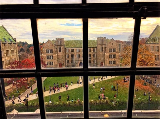 Students walk through a campus quadrangle.