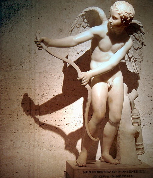 Classical statue of Cupid with his bow