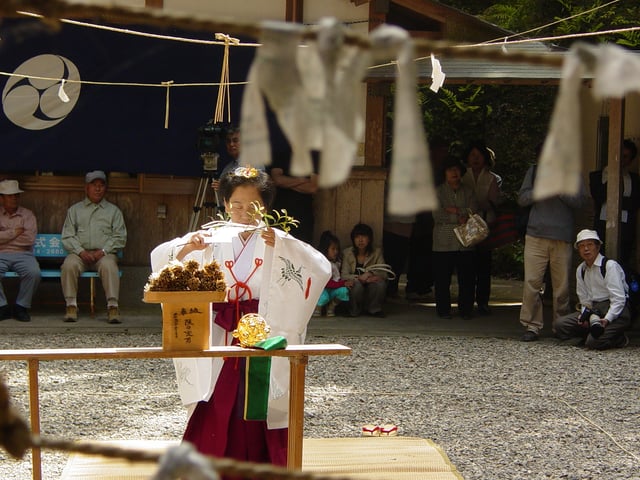 A miko (woman consecrated to a Shinto deity) at Inari Shrine.