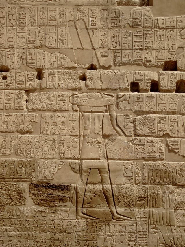 The Triumphal Relief of Shoshenq I near the Bubastite Portal at Karnak, depicting the god Amun-Re receiving a list of cities and villages conquered by the king in his Near Eastern military campaigns.