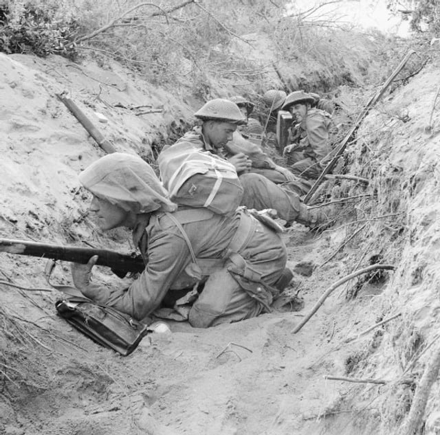 Men of 'D' Company, 1st Battalion, Green Howards, part of 15th Brigade of British 5th Division, occupy a captured German communications trench during the breakout at Anzio, Italy, 22 May 1944.