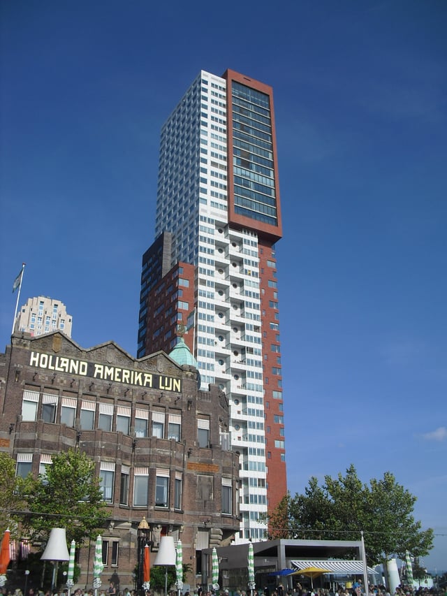 The former headquarters of the Holland America Line next to modern residential architecture in 2010
