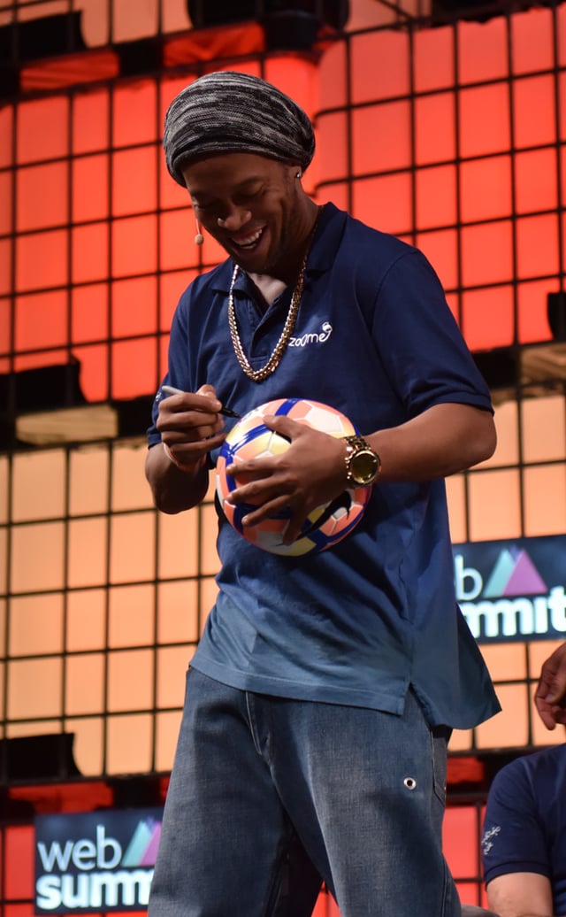 Ronaldinho signing a football at the Web Summit in November 2016