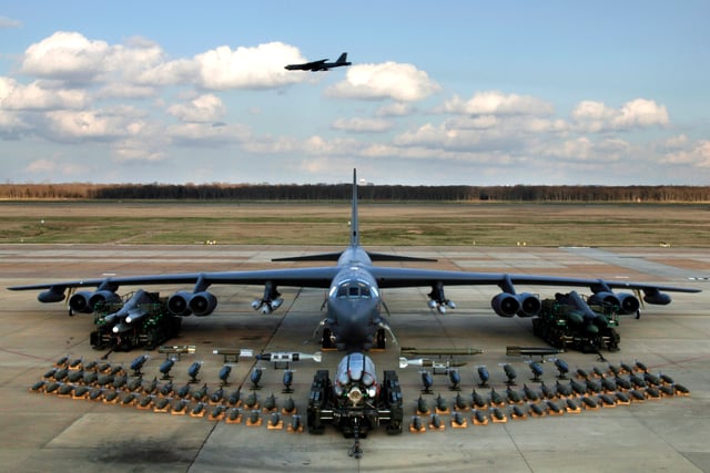 Boeing B-52H static display with weapons, Barksdale AFB 2006. A second B-52H can be seen in flight in the background