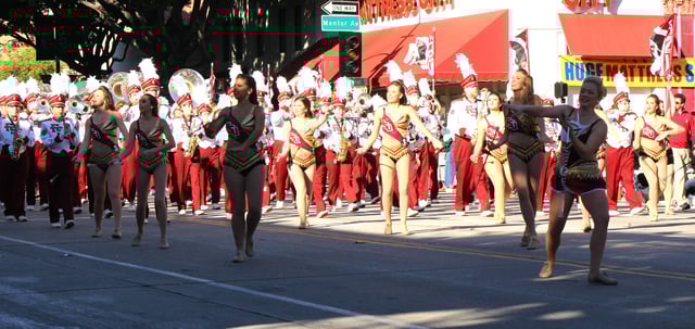 FSU Marching Chiefs and Cheerleaders performing in a parade in Downtown Tallahassee