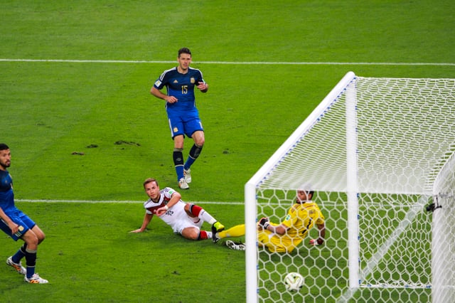 Mario Götze scoring the winning goal for Germany as Ezequiel Garay (left), Demichelis (centre) and goalkeeper Sergio Romero look on during the 2014 World Cup Final