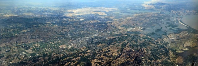 Aerial view from the west of lower Napa Valley, from Yountville (lower left) to San Pablo Bay (upper right), with Napa at center