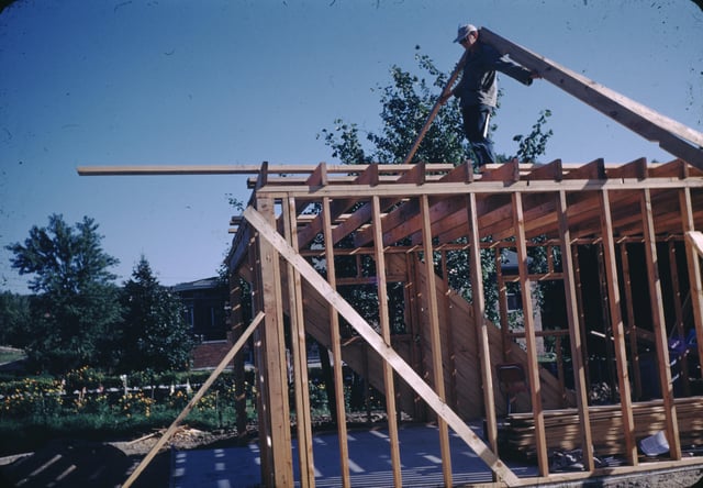 A roof being framed in the United States circa 1955