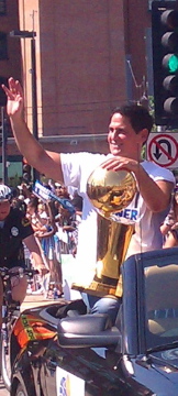 Mavericks owner Mark Cuban holding the Larry O'Brien Championship Trophy during the championship parade.