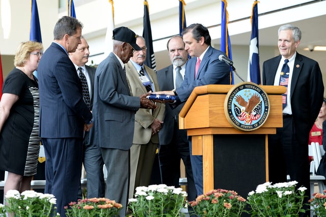 Cruz presents a U.S. flag to World War II veteran Richard Arvine Overton during opening ceremony for outpatient clinic in Austin on August 22, 2013