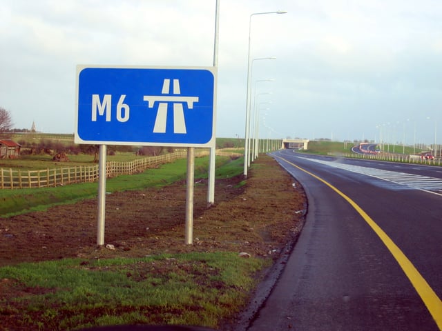 Signage on the M6 near Kinnegad in Ireland. This is a standard sign in many European countries to indicate the start of motorway regulations. In this case the appropriate motorway number is shown and in accordance with Irish practice a continuous yellow line indicates a motorway rather than a high-quality dual carriageway (HQDC).