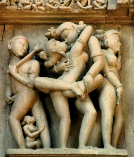 Erotic sculpture at Khajuraho Temple walls.