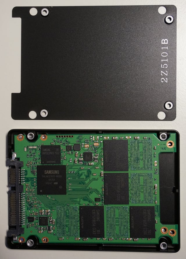 An SSD with HDD form factor, opened to show solid state electronics