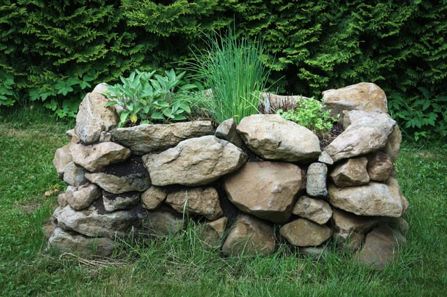 Raised garden bed with natural stones