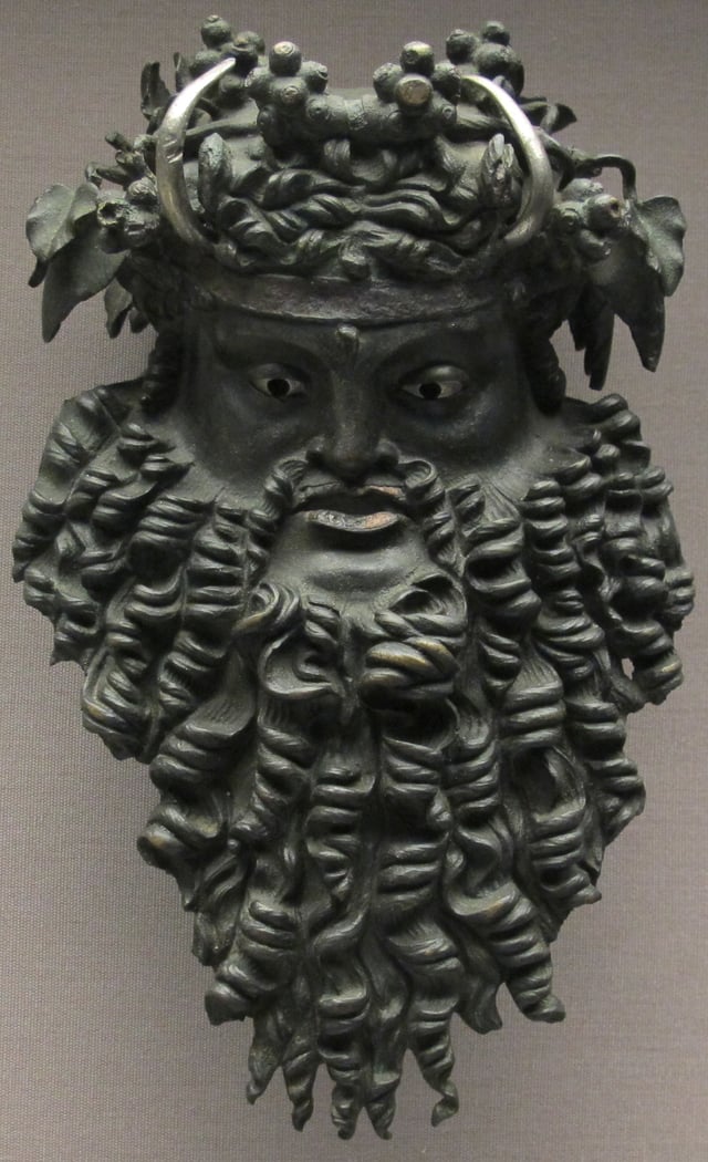 Bronze mask depicting Dionysus bearded and horned, 200 BC - 100 AD.