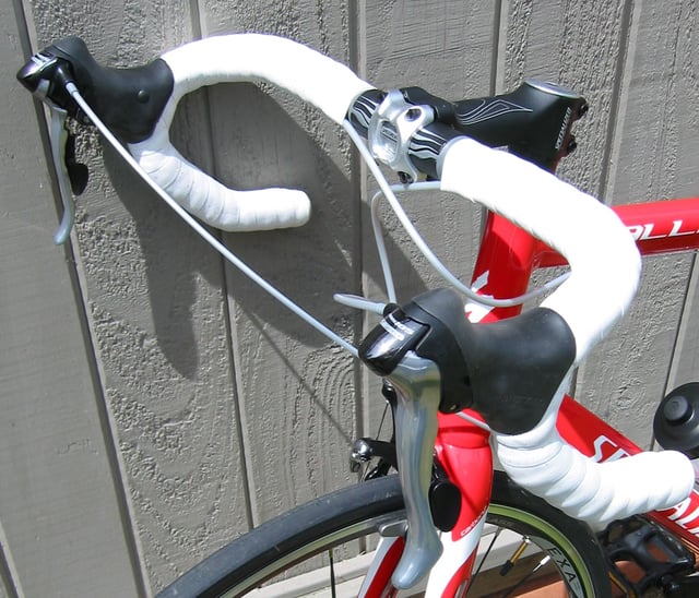 Brake levers on the drop handlebars of a road bike with integrated shifters