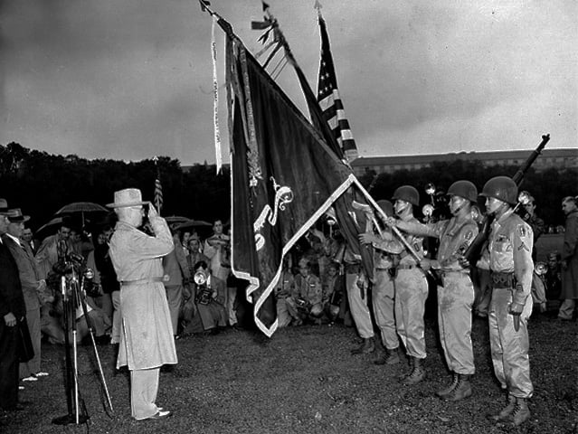 President Truman salutes the colors of the combined 100th Battalion, 442nd Infantry, during the presentation of the seventh Presidential Unit Citation. The Regimental Combat Team (less the 552d Field Artillery Battalion) received the Presidential Unit Citation for outstanding accomplishments in combat in the vicinity of Serravezza, Carrara, and Fosdinovo, Italy, from 5 April to 14 April 1945.