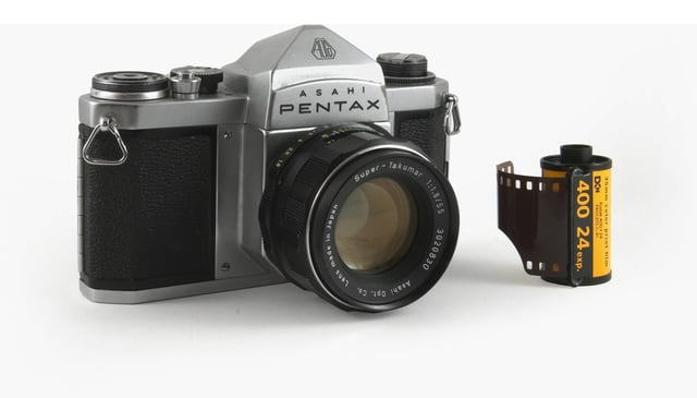Kodak 35mm film cartridge alongside Asahi Pentax film camera. The shift from film to digital greatly affected Kodak's business.