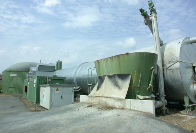 Farmyard anaerobic digester converts waste plant material and manure from livestock into biogas fuel.