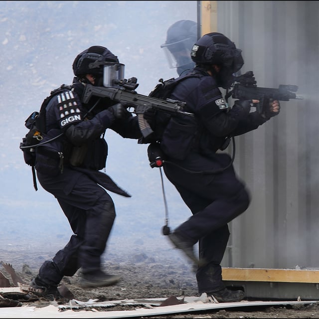 Assault team entering a building.