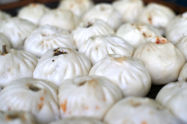 Bāozi are steamed buns containing savory or sweet combinations of meat, vegetables, mushrooms, traditionally associated with breakfast.