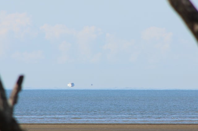 Fata Morgana, a type of mirage in which objects located below the astronomical horizon appear to be hovering in the sky just above the horizon, may be responsible for some UFO sightings. (Here, the shape floating above the horizon is the reflected image of a boat.) Fata Morgana can also distort the appearance of distant objects, sometimes making them unrecognizable