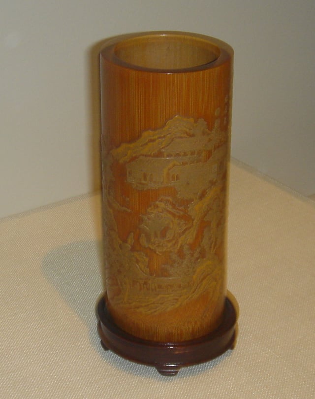 A cylindrical bamboo brush holder or holder of poems on scrolls, created by Zhang Xihuang in the 17th century, late Ming or early Qing Dynasty – in the calligraphy of Zhang's style, the poem Returning to My Farm in the Field by the fourth-century poet Tao Yuanming is incised on the holder.