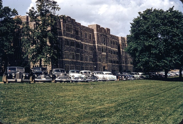 Chevrolet Deluxe cars parked in front of Patton Hall, ca 1952