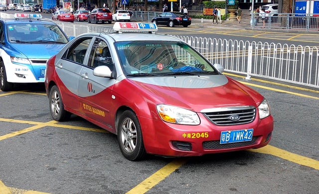 A red fuel taxi, with an electric blue taxi behind it