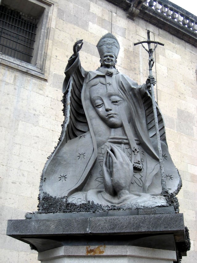 A statue of Pope John Paul II with an image of the Virgin of Guadalupe, near the Metropolitan Cathedral in Mexico City. The statue was made entirely of metal keys donated by the Mexican people.