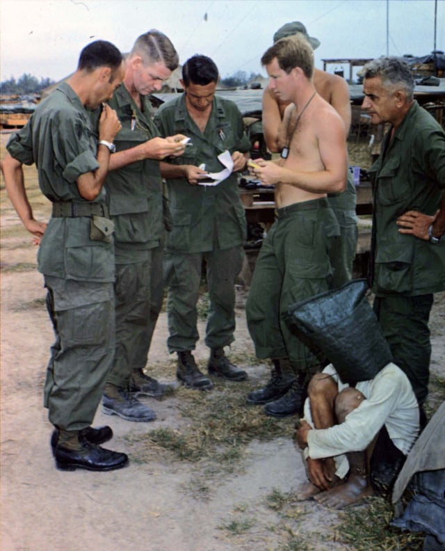 An alleged Viet Cong captured during an attack on an American outpost near the Cambodian border is interrogated.