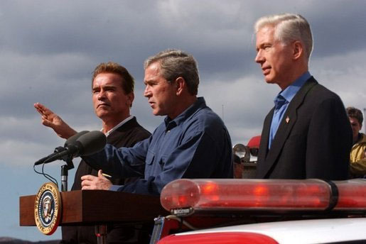Governor-elect Arnold Schwarzenegger, President George W. Bush and Governor Gray Davis speak to firefighters on November 4, 2003.