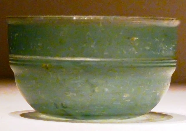 A green Roman glass cup unearthed from an Eastern Han Dynasty (25–220 AD) tomb in Guangxi, southern China; the earliest Roman glassware found in China was discovered in a Western Han tomb in Guangzhou, dated to the early 1st century BC, and ostensibly came via the maritime route through the South China Sea