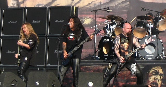 Thrash metal band Slayer performing in 2007 in front of a wall of speaker stacks.