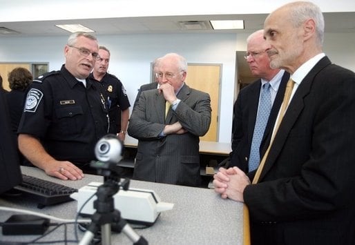 A U.S. Customs and Border Protection Officer addresses Dick Cheney (center), then Vice President of the United States, Saxby Chambliss (center right), a U.S. Senator from Georgia and Michael Chertoff (far right), then United States Secretary of Homeland Security, in 2005