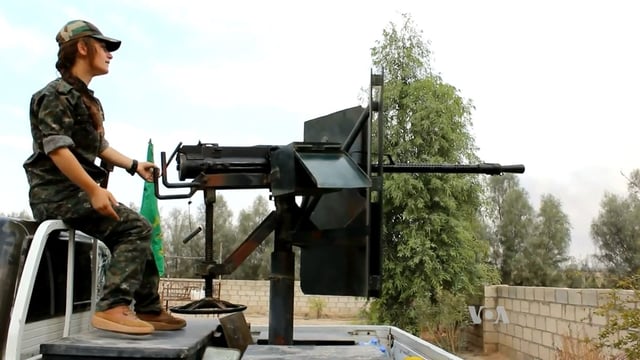 YPJ fighter on the Back of a technical