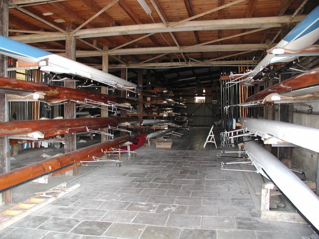 Racing shells stored in a boathouse.